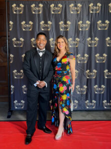 A man and woman posing for a picture on the red carpet.