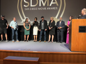 A group of people standing on stage at the sdma awards.
